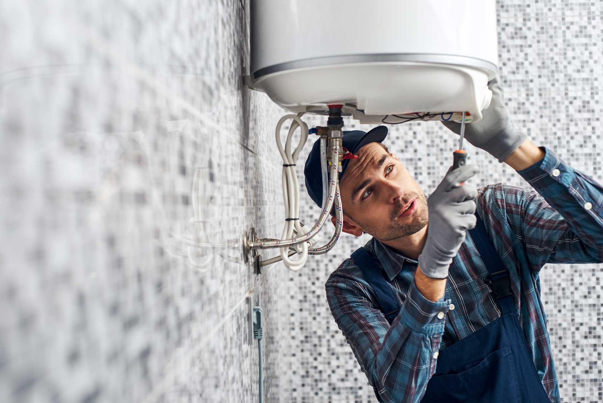 A plumber working under a sink