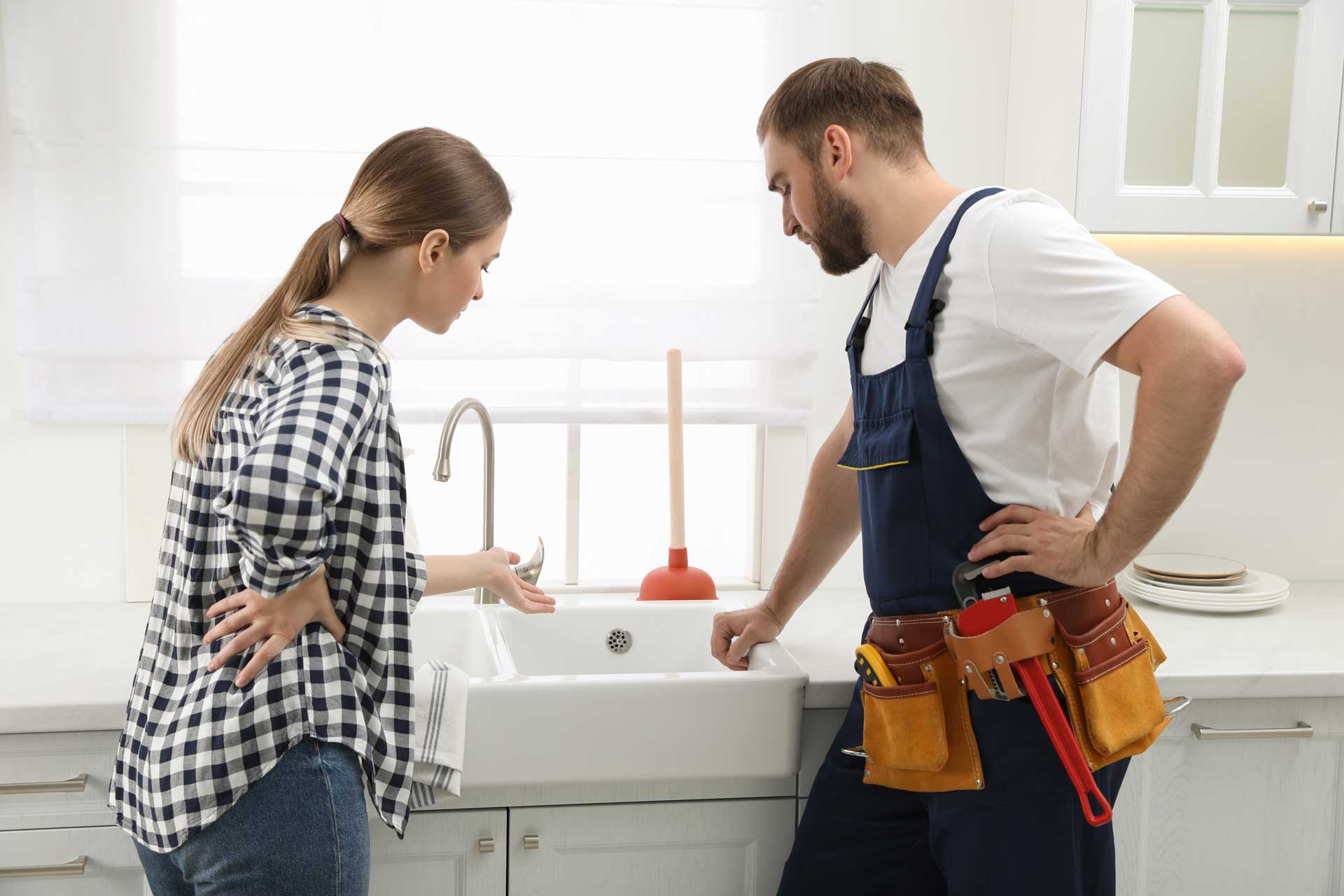 A plumber speaking with a client