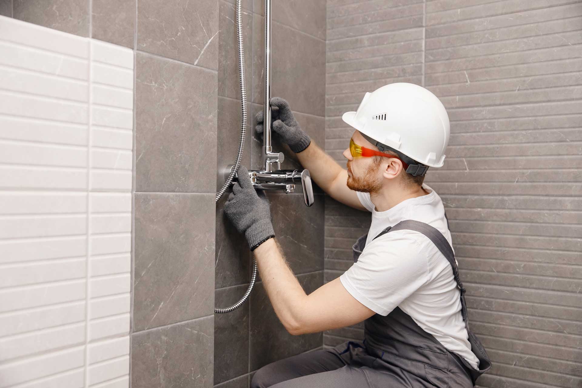 A plumber working on a shower