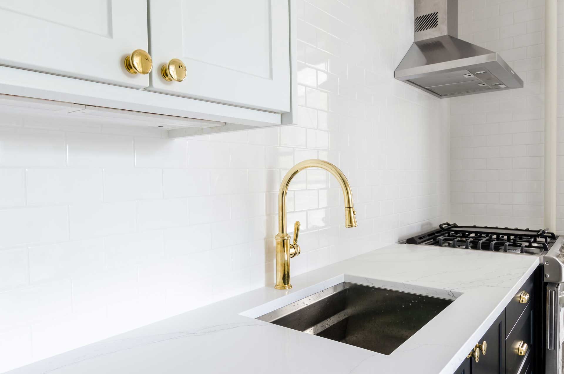 A white marble kitchen countertop with a sink